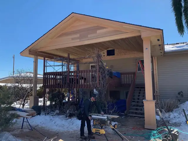 A patio cover under construction with framing in place