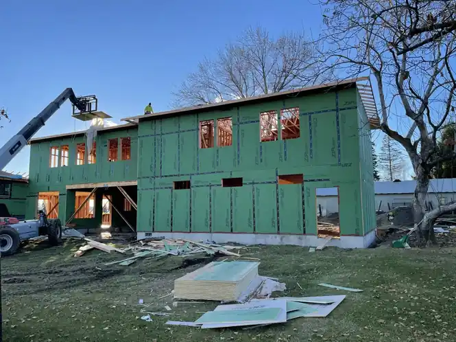 A telehandler setting material beside the ZIP-sheathed build